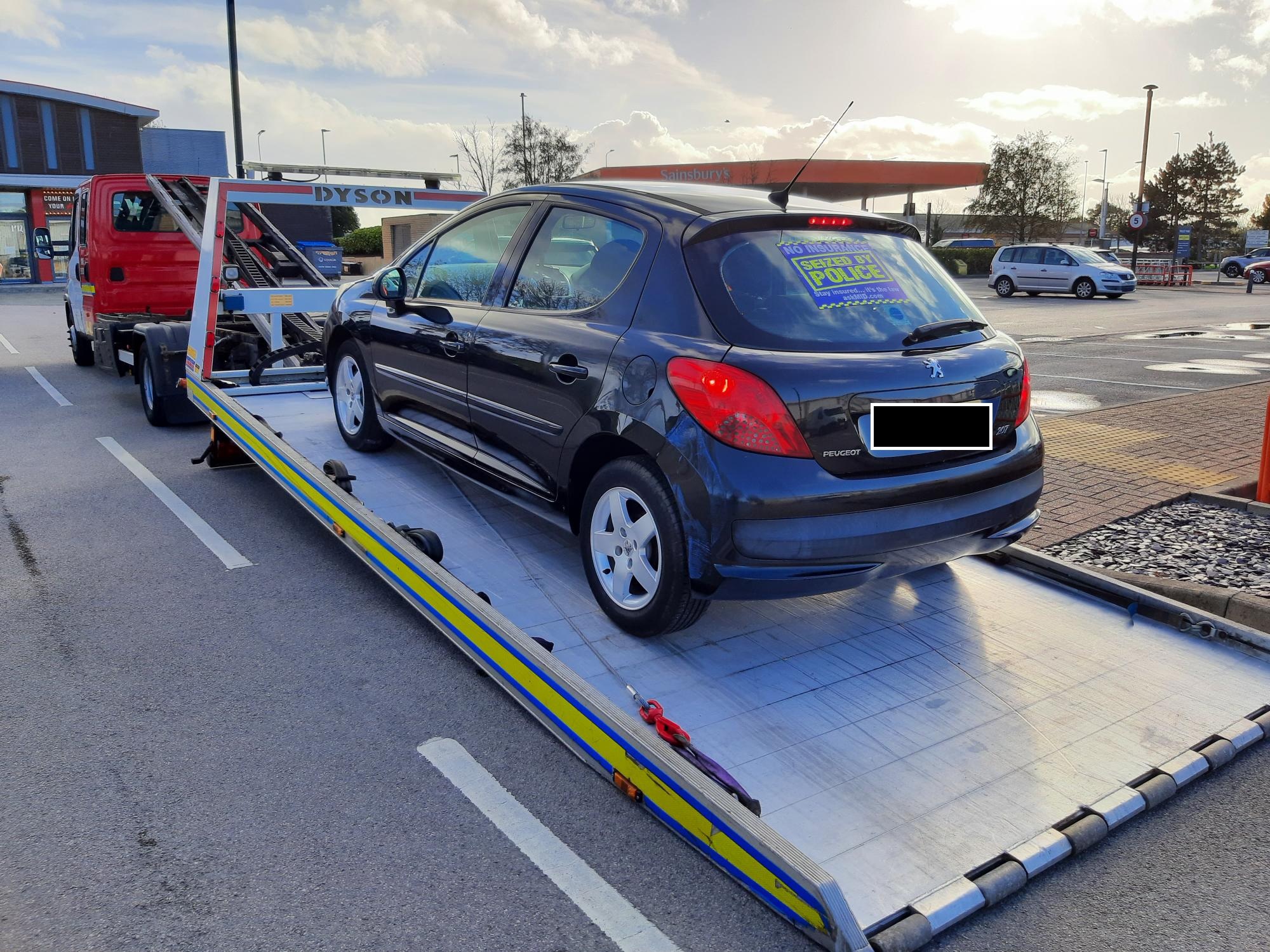 Photograph of a car being seized