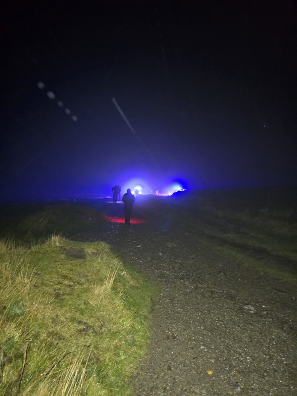 Police officers, staff, volunteers and partners lit up Moel Famau on an annual blue light walk to raise awareness of mental health