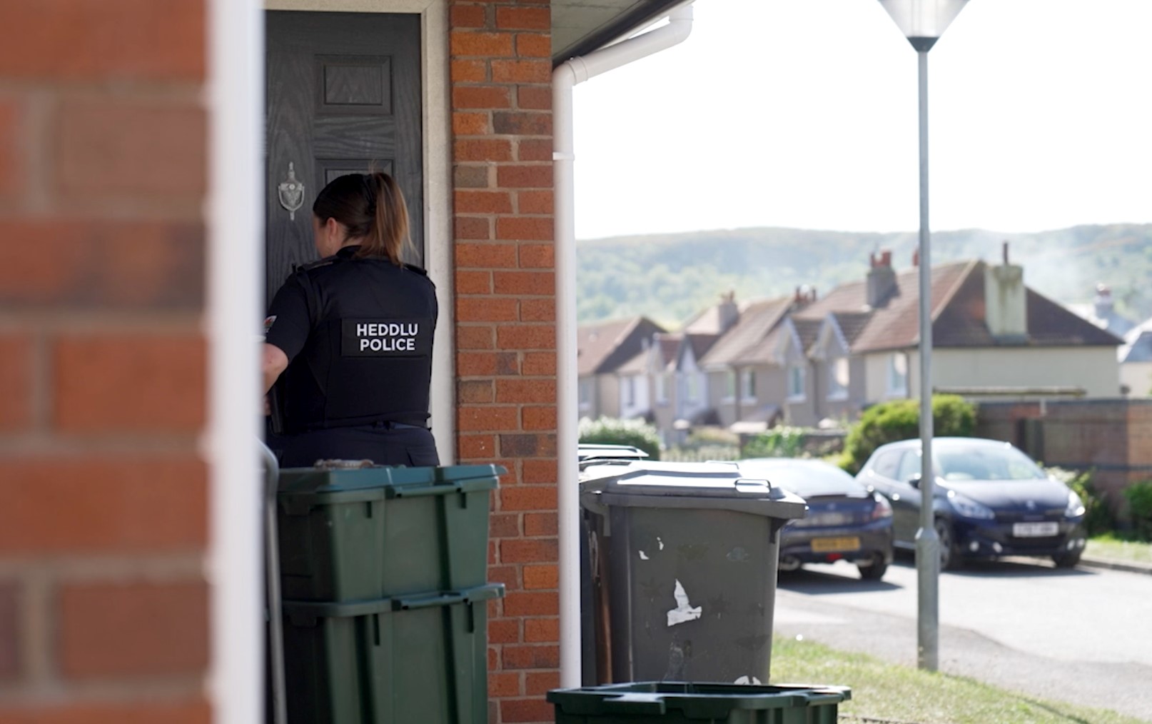 Photograph of an officer at a door