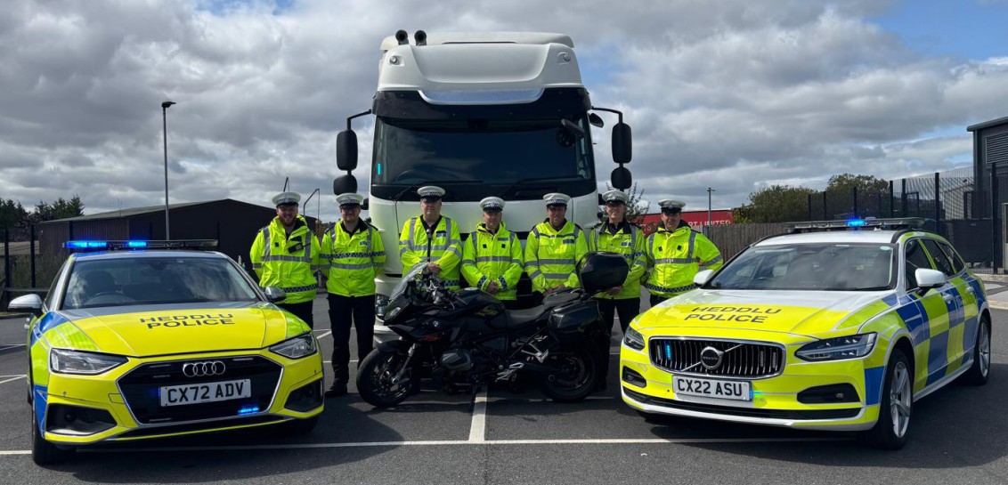 Photograph of the officers with the HGV