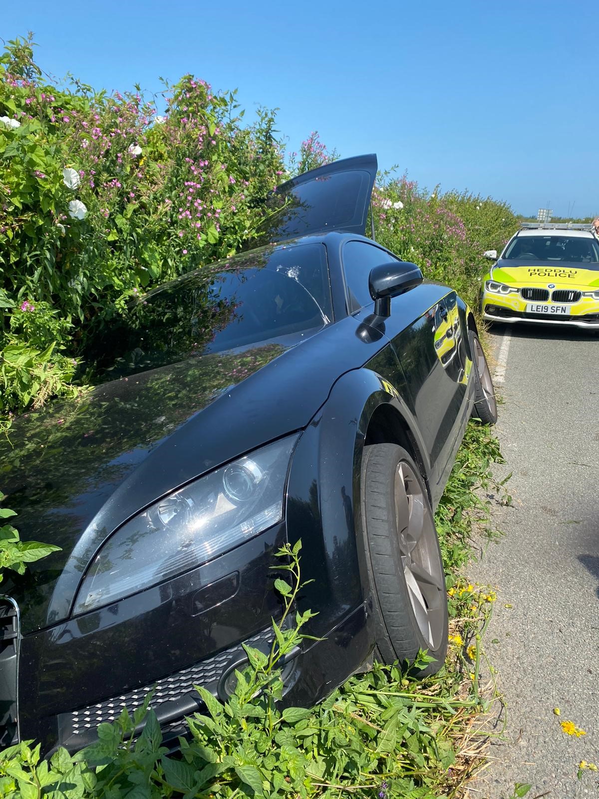 Photograph of a car in a ditch