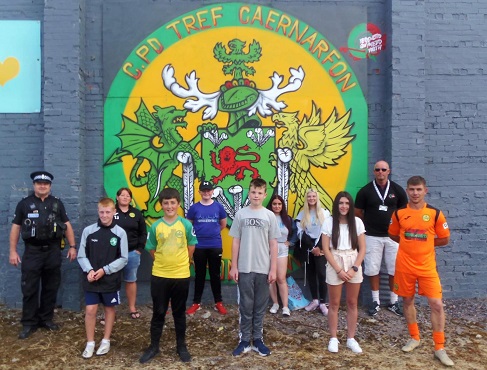 Group photo in front of mural
